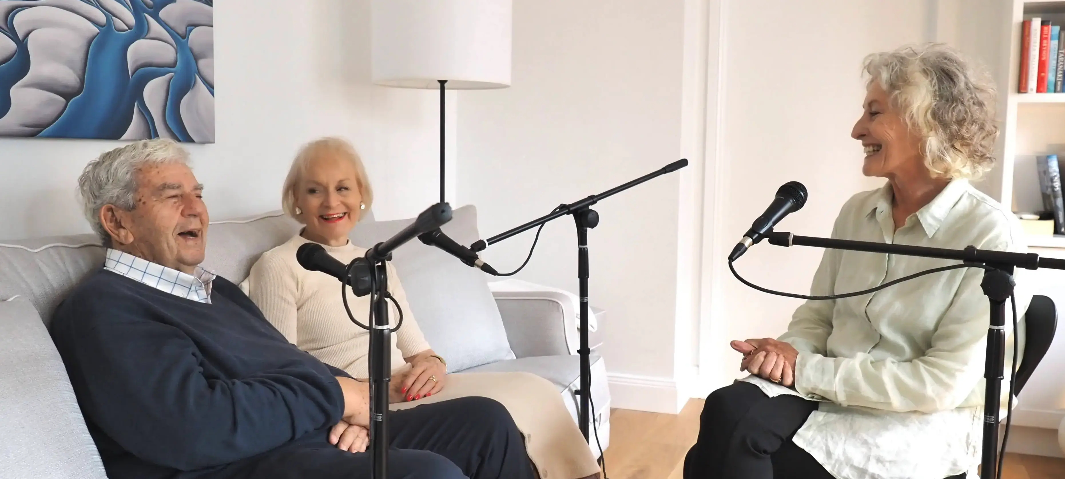 Three people recording an interview in a lounge room